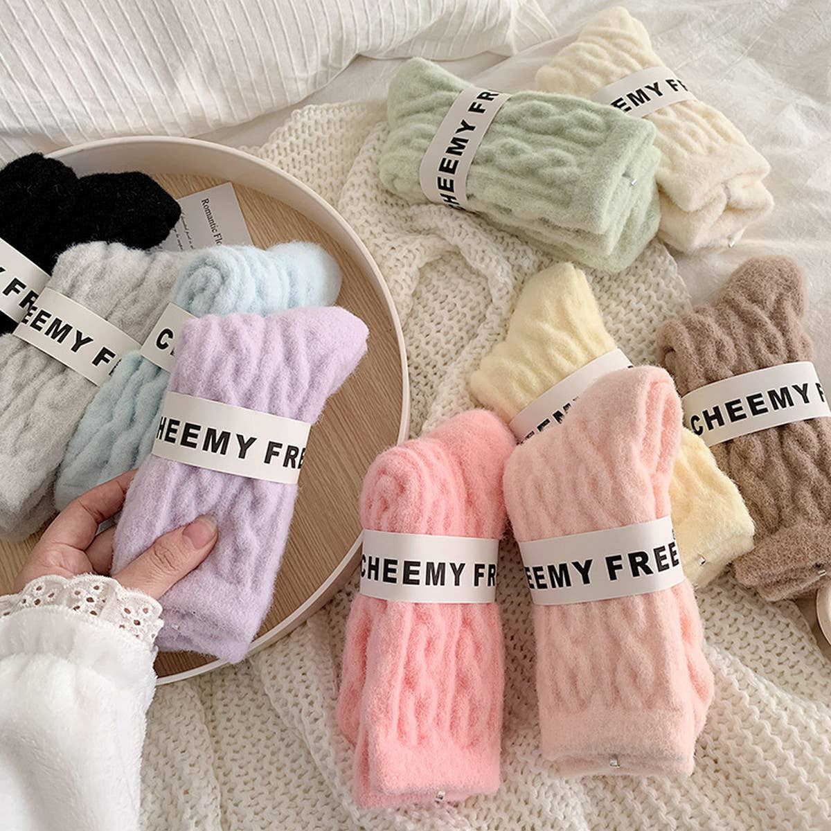 Colorful socks with 'CHEEMY FREE' labels on a white surface