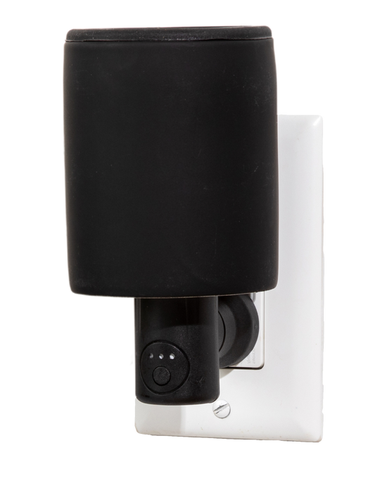Black wax melter plugged into the wall