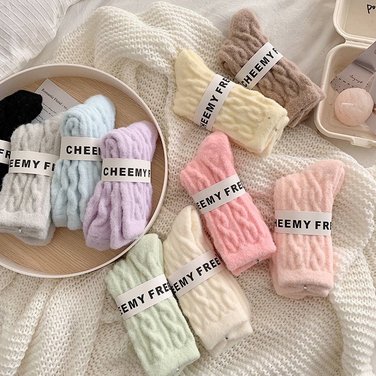 Colorful socks with 'CHEEMY FREE' labels on a textured surface