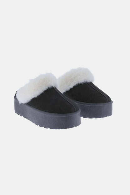 black slipper against white background