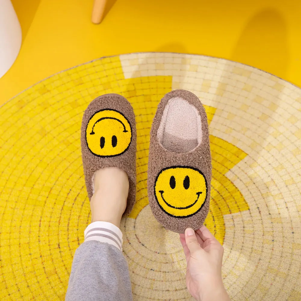 Brown furry slippers with a yellow smiley face