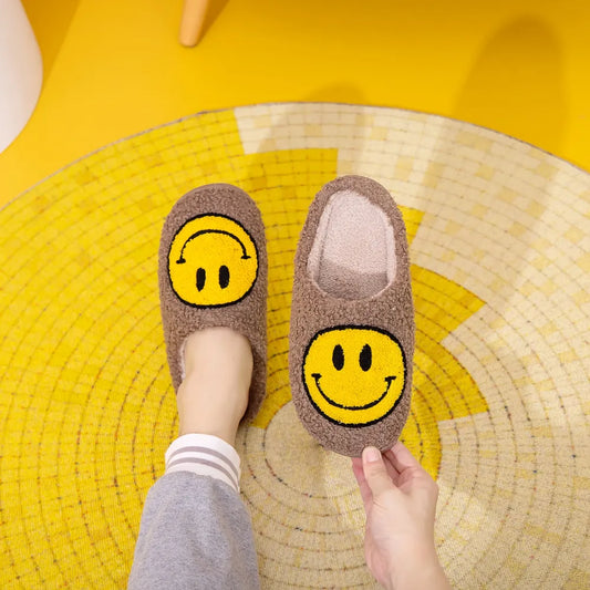 Brown furry slippers with a yellow smiley face