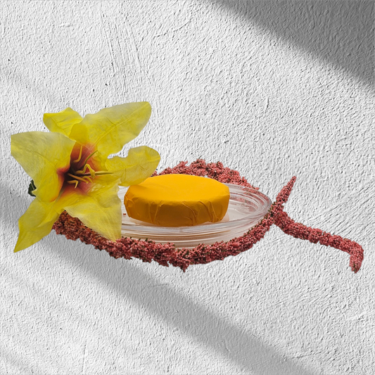 Verity Collectives Citrus Mint Shower Steamer wrapped in orange and greenish tinted tissue paper with a reddish flower and white background