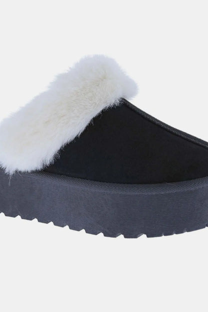 black slipper with white fur and thick sole