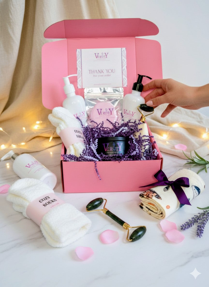 Pink gift box with Verity Collectives  skincare products and accessories on a white background