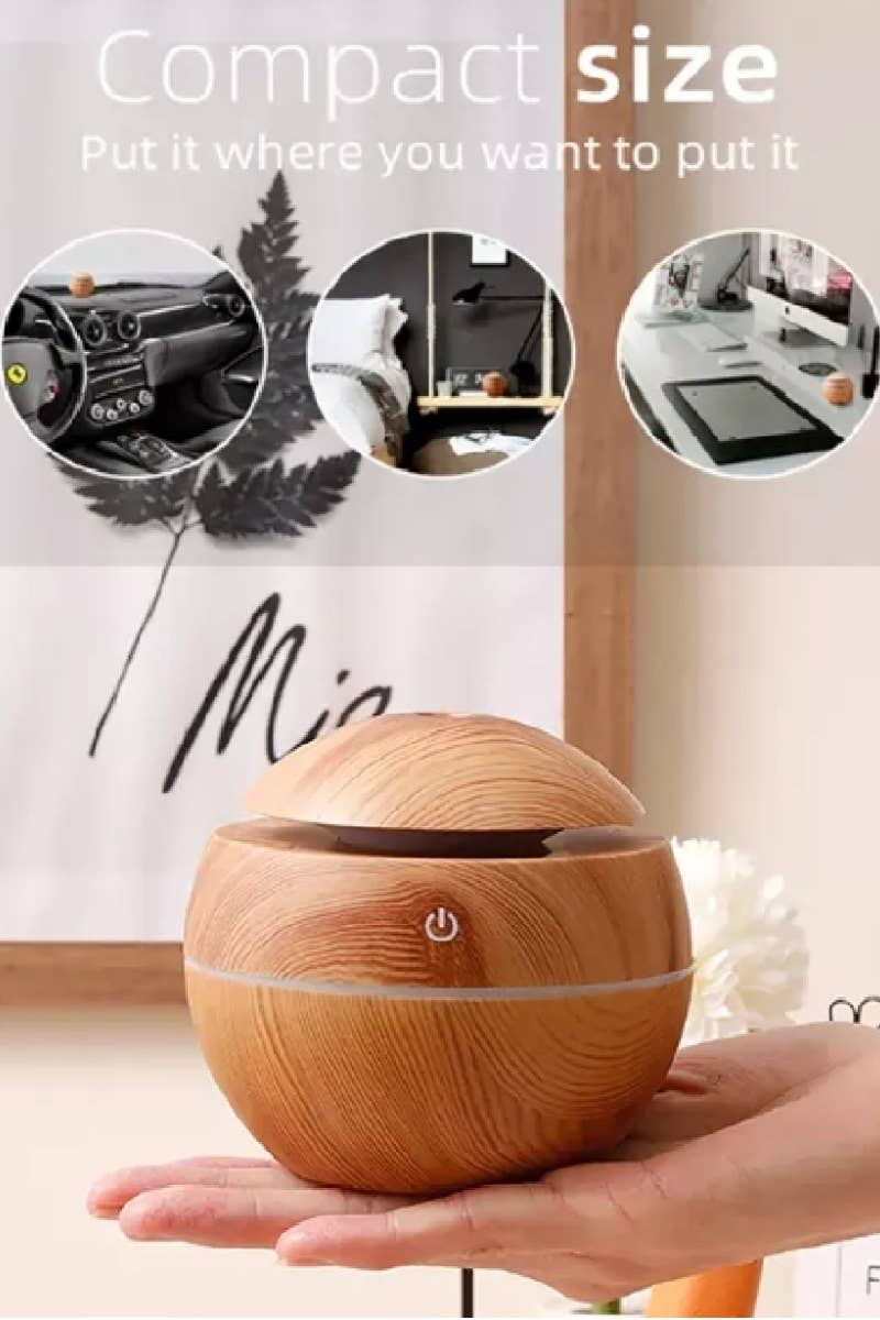mini light wood humidifier showing compact size in someone's hand 