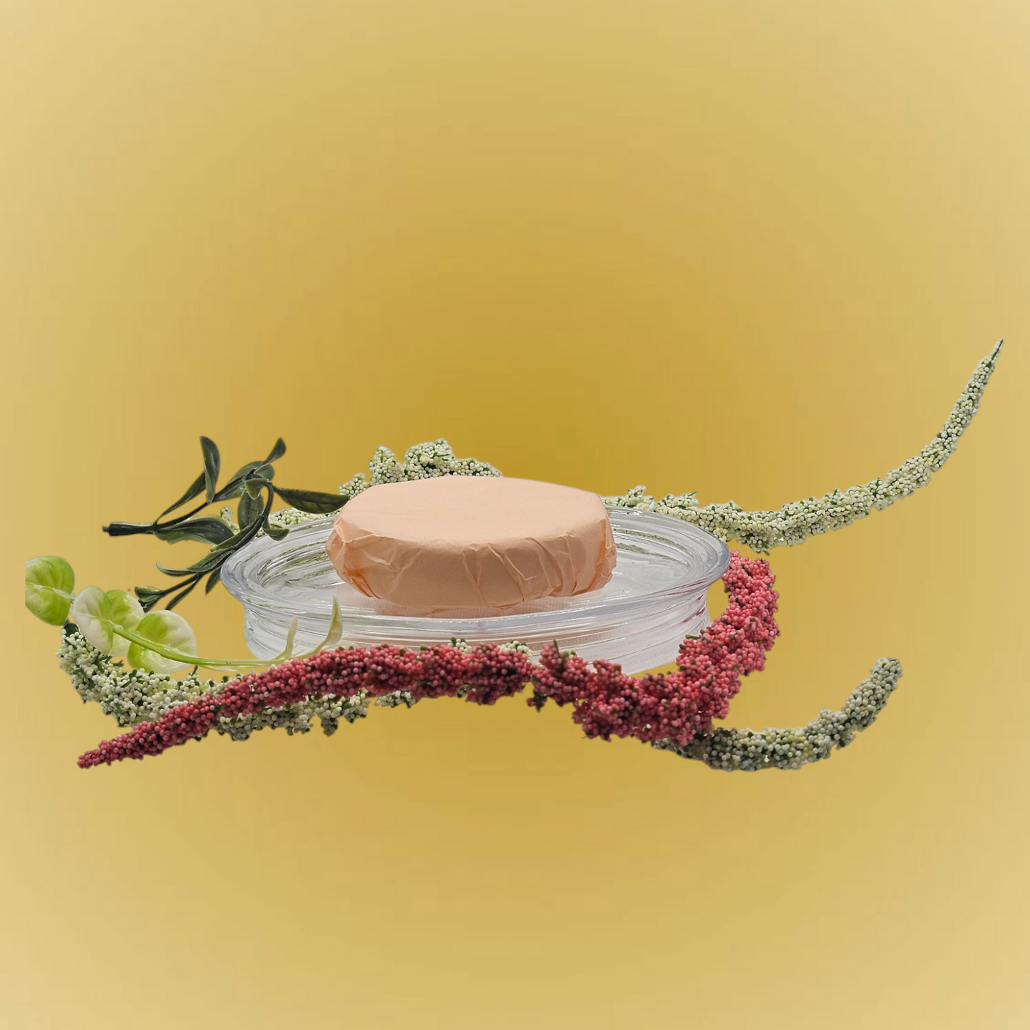 Verity Collectives Crisp Morning Shower Steamer wrapped in peach colored tissue paper with greenish and red flowers and light yellow background