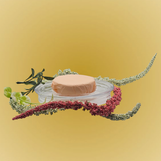 Verity Collectives Crisp Morning Shower Steamer wrapped in peach colored tissue paper with greenish and red flowers and light yellow background