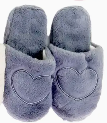Pair of gray slippers with heart designs on a white background