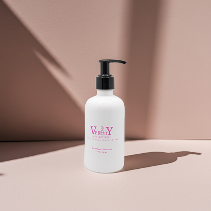 White bottle with black pump and Verity Collectives branding on a beige background