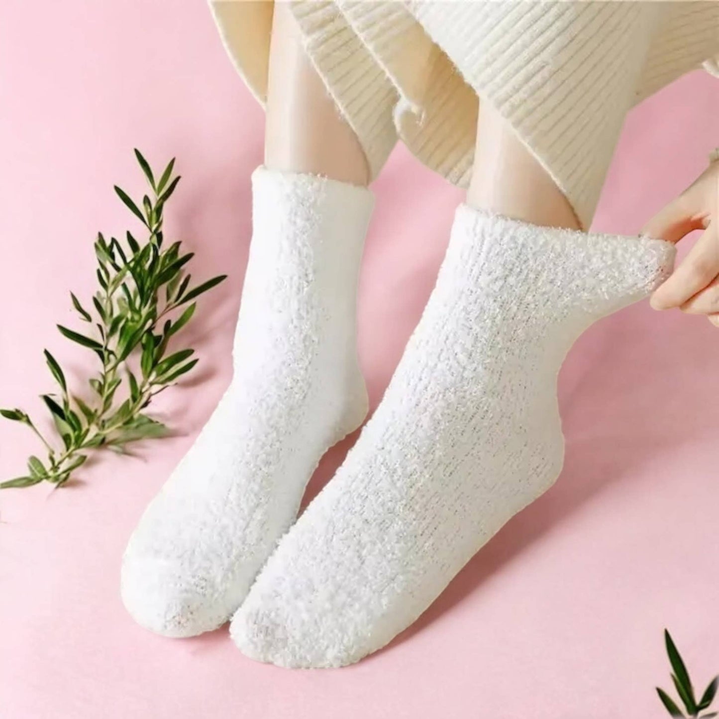 person wearing comfy pants and comfy white fluffy socks on pink carpet