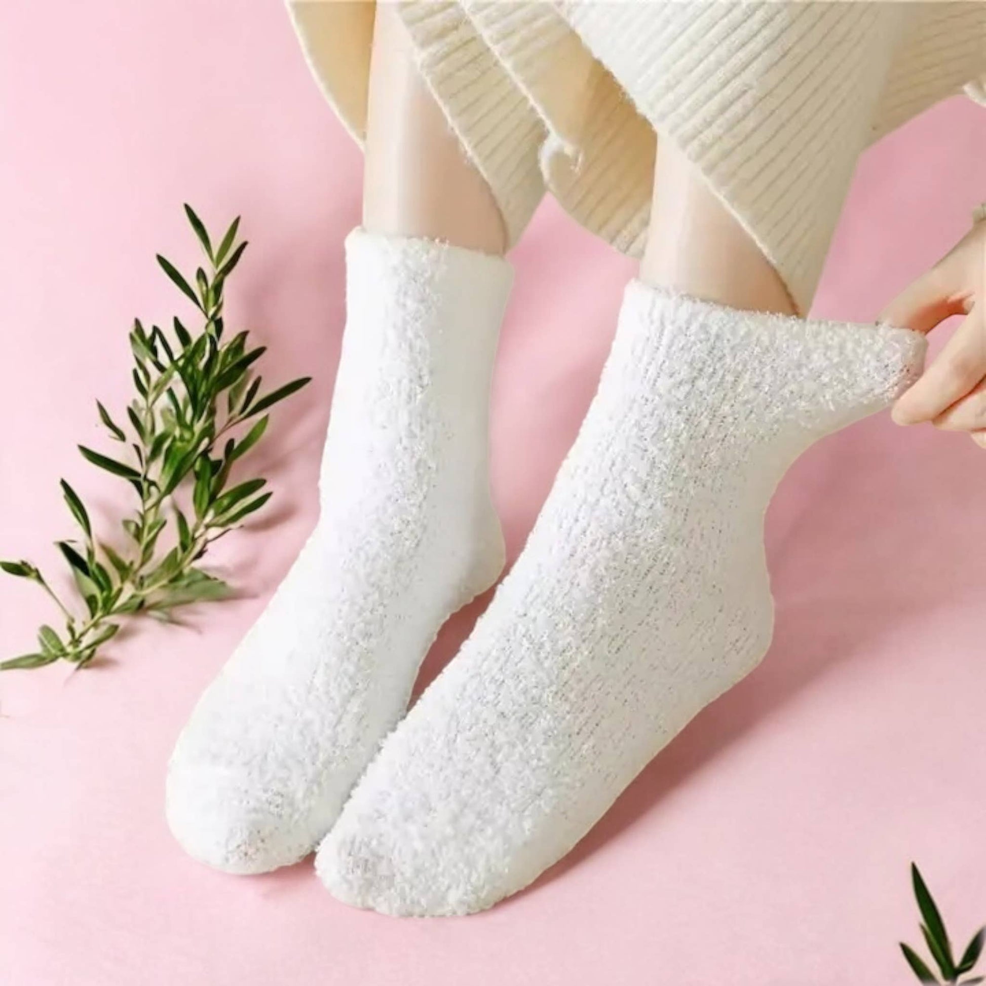 person wearing comfy pants and comfy white fluffy socks on pink carpet