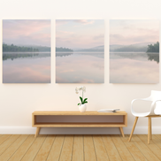 Three-panel misty lake canvas set with blush and pale blue sky, pine-covered shores, and mirror-still water