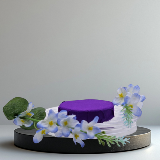 Verity Collectives Lavender Shower Steamer wrapped in purple tissue paper with a lavender flower and white background
