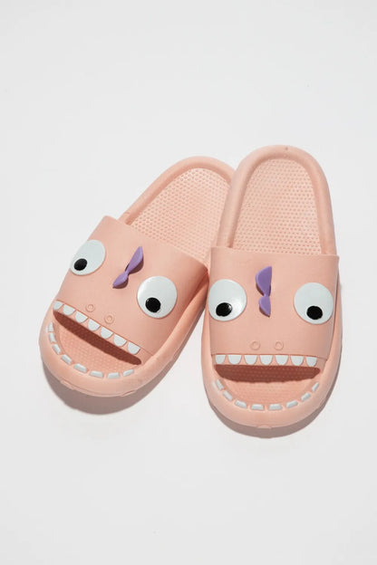 Orange slide slippers with a non scary monster face