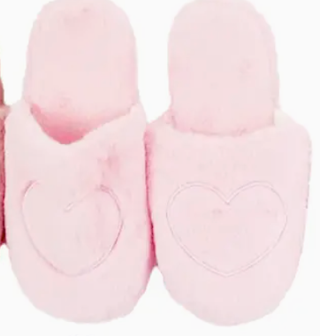 Pair of pink slippers with heart designs on a white background