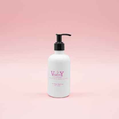 White Verity Collectives bottle with black pump on a pink background