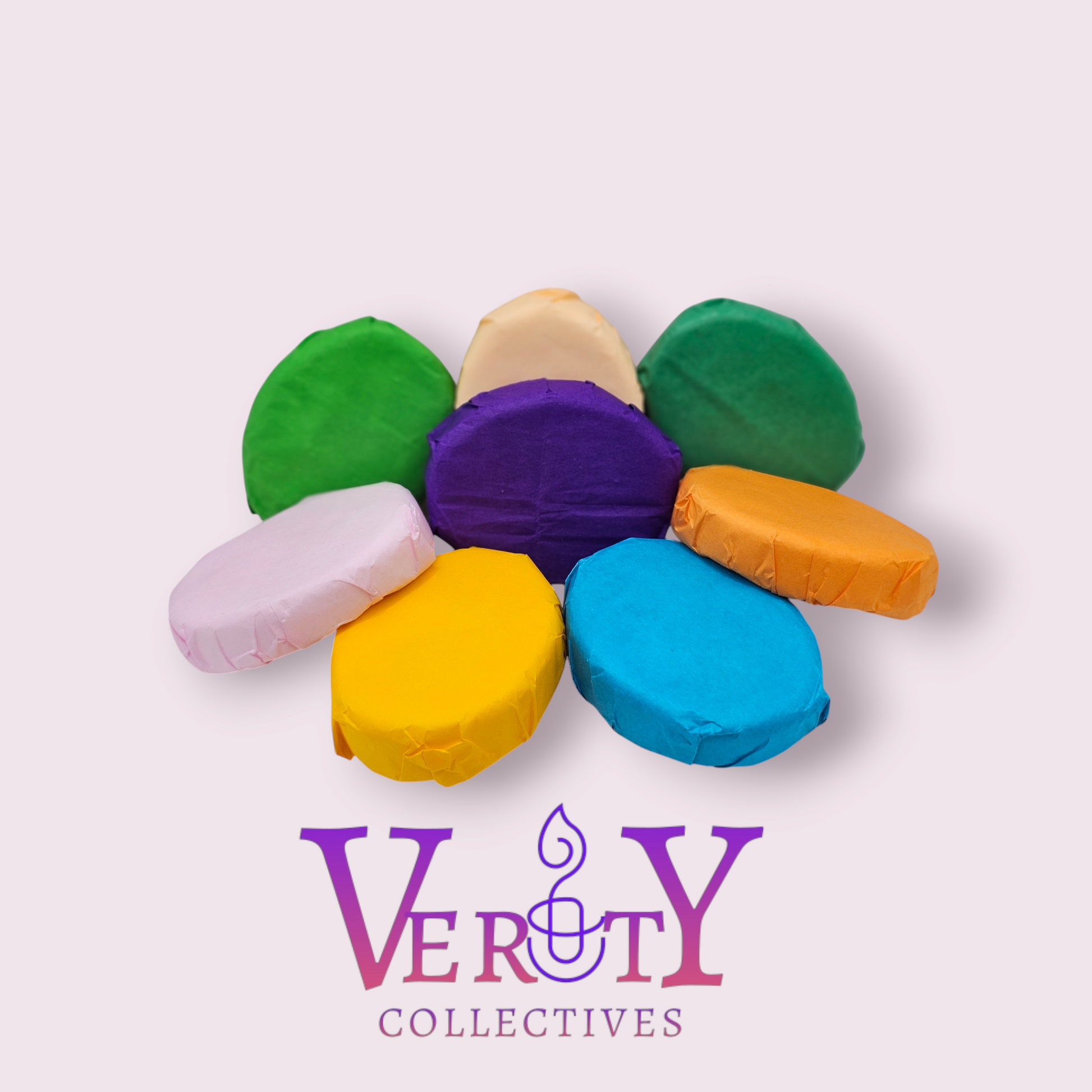 All Verity Collectives Shower Steamers wrapped in different colored tissue paper with a pink background