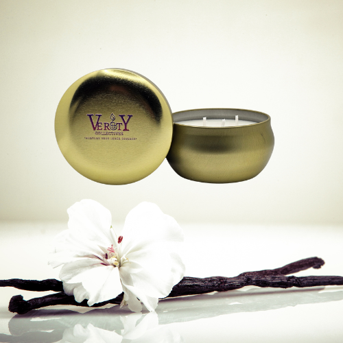 Verity Collectives Gold Candle Honey Vanilla with vanilla flower in the background