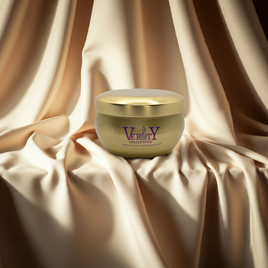 Gold candle sitting on shelf with ivory colored backdrop