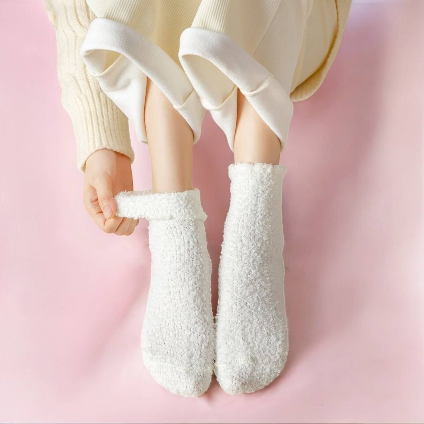 white fluffy socks on person with comfy clothes on