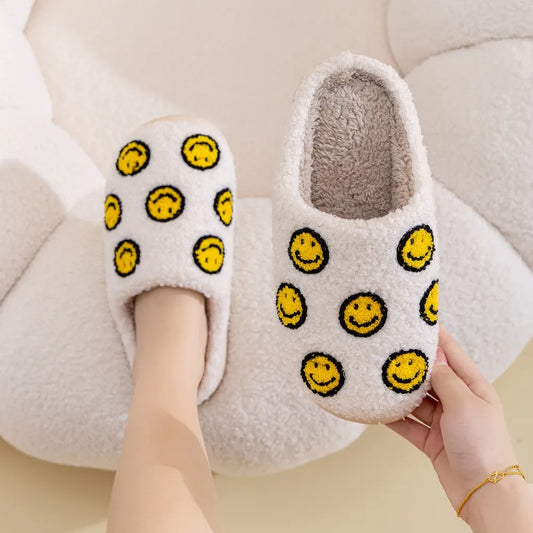 White furry slipper with lots of small yellow smiley faces