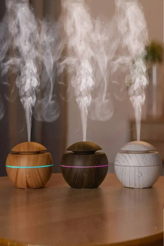 three mini diffusers blowing humid air on top of table