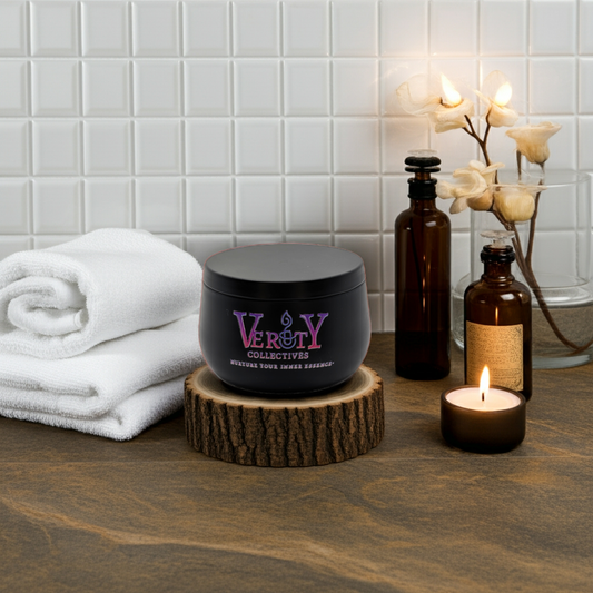 Black container with 'Verity Collectives' branding on a wooden surface with towels and candles in the background.