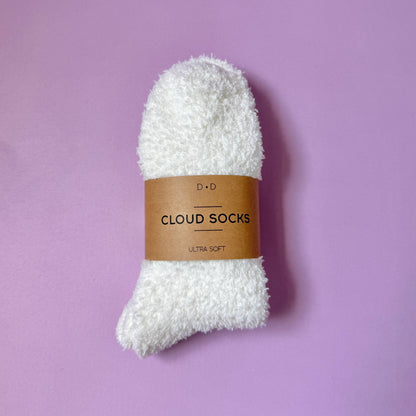 fluffy white cloud socks against lavender background